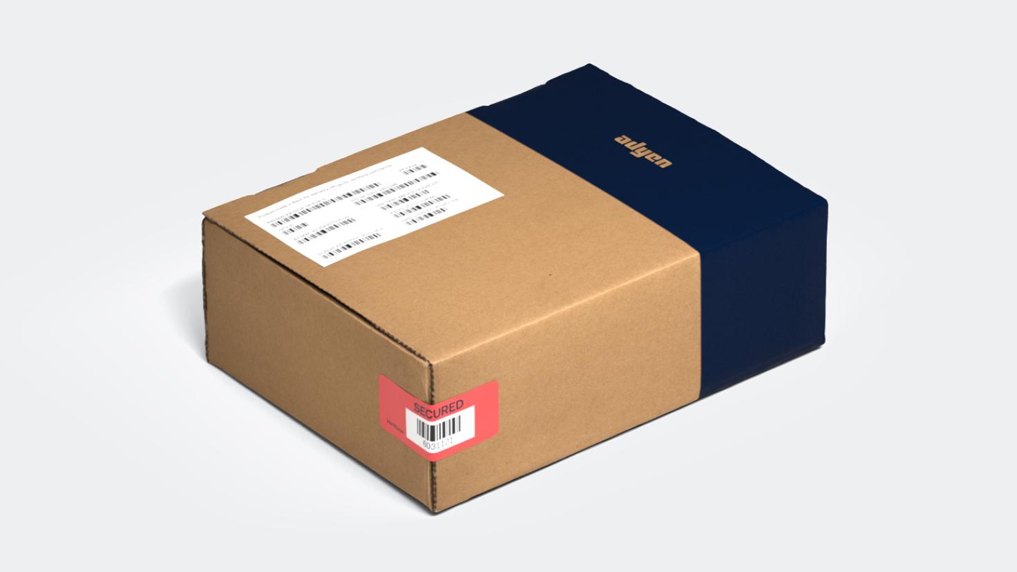 Cardboard box with blue Adyen branding and secured label